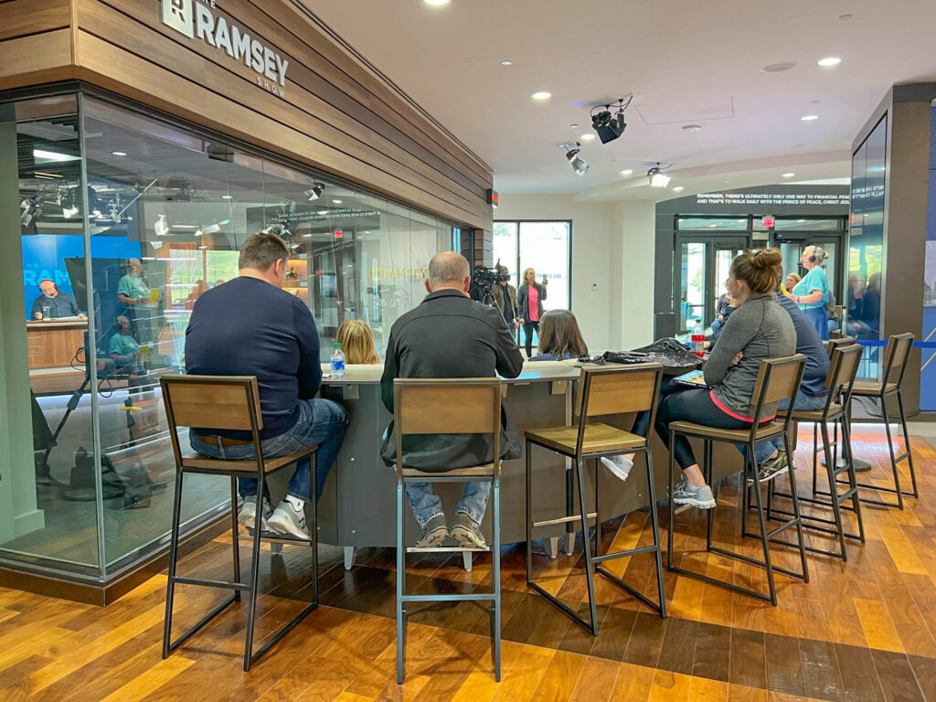 Seating area in front of the recording studio with a person getting ready to tell their story and deliver a "Debt Free Scream"