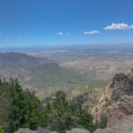 You made it to the top. Welcome to the saddle of Sandia Peak, where the views stretch for miles and the wind tries to steal your hat.