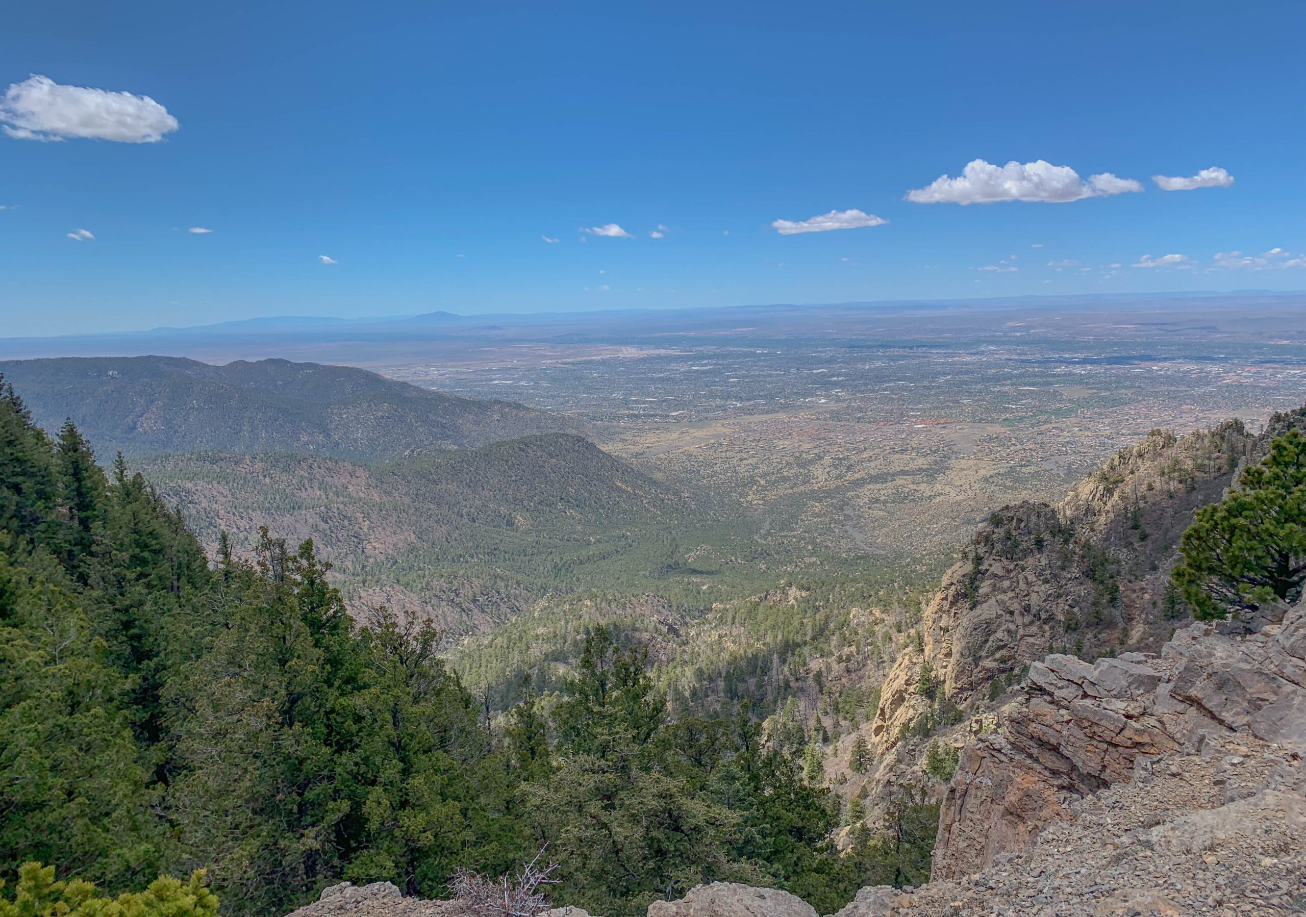 You made it to the top. Welcome to the saddle of Sandia Peak, where the views stretch for miles and the wind tries to steal your hat.