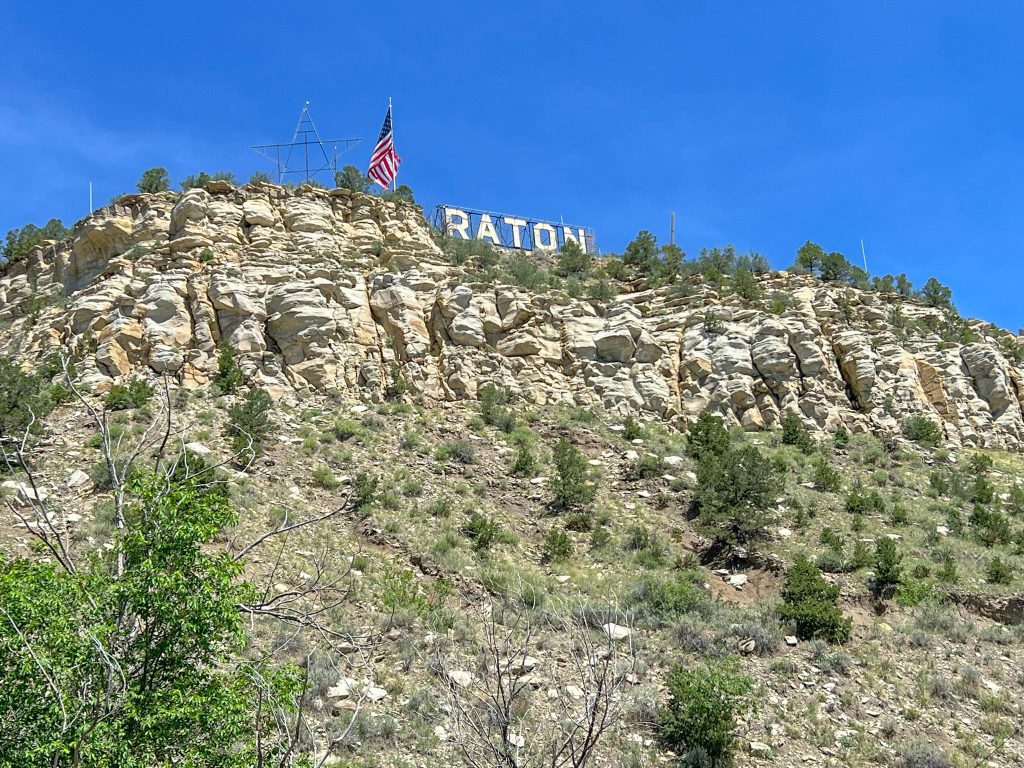 Raton sign on top of a hill overlooking the town