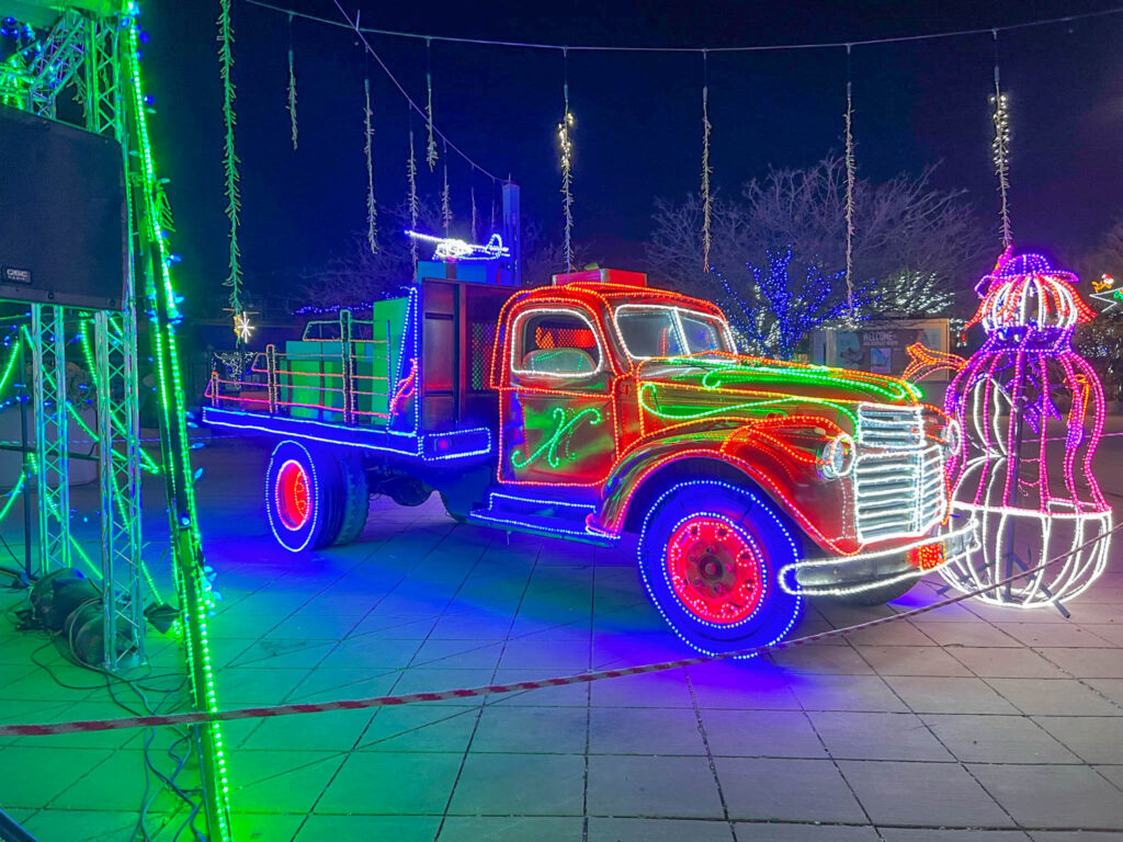A lit-up truck at the entrance to the River of Lights.  