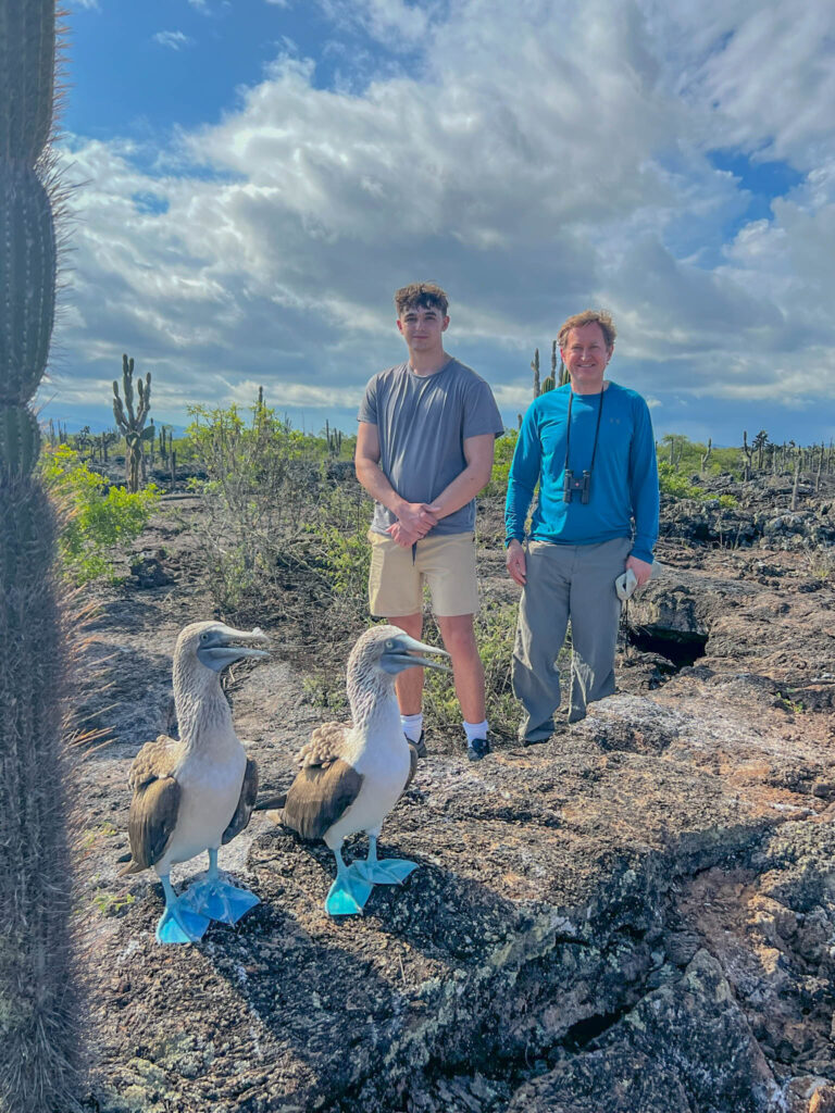 Posing with blue-footed boobies on Isabela Island