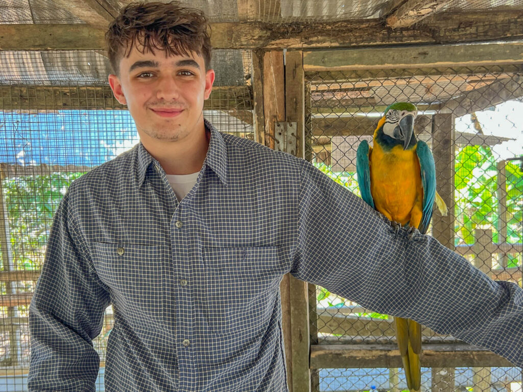 Posing with a blue and gold macaw