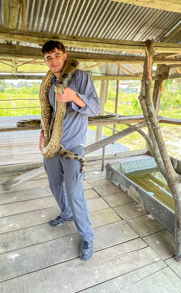 Erik's dream comes true - he gets to hold a green anaconda.  