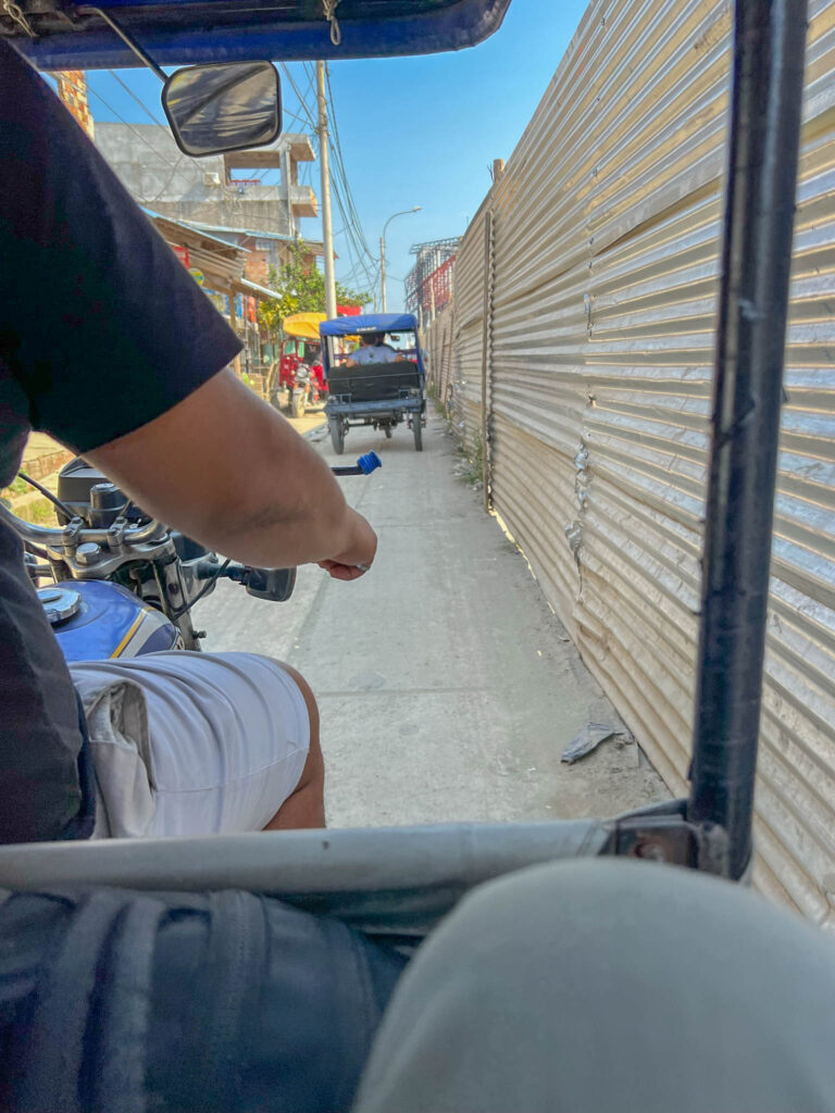 Travel the narrow back streets of Iquitos to get to our boat