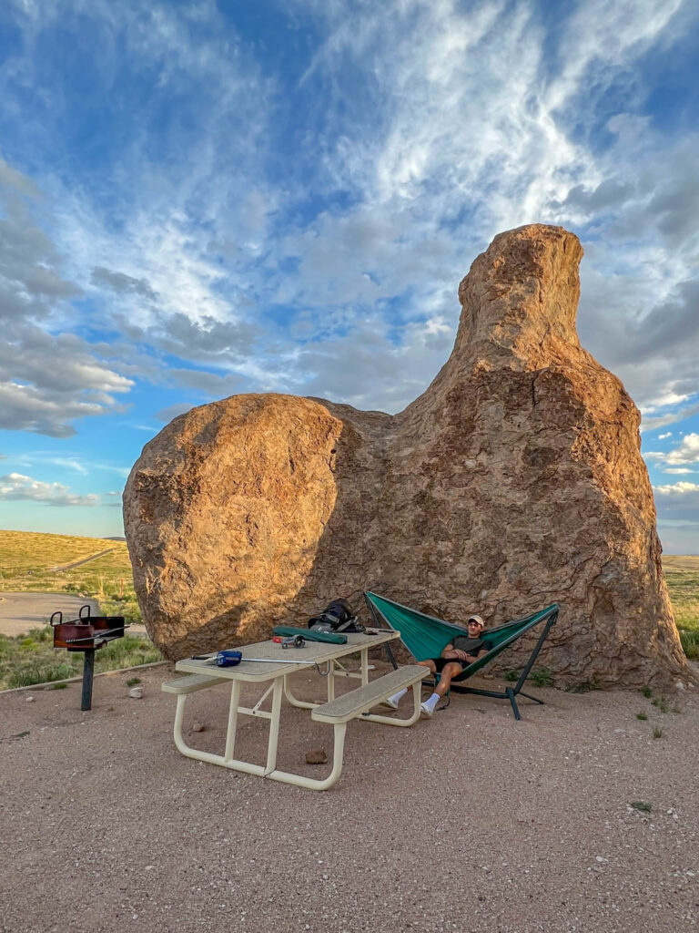 My son sets up his hammock among the rocks