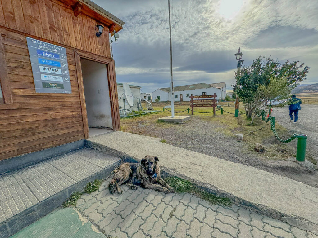 A dog relaxes in front of the Argentina portion of the border crossing.
