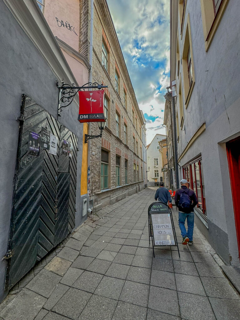 Tallinn has lots of narrow alleys to explore. The door on the left is the entrance to DM BAAR, a bar that's devoted to the band called Depeche Mode. For the youngsters out there, Depeche Mode is an English band that was huge in the alternative and electronic music scene in the 1980s and 1990s. They even put out an album in 2023, so they're still alive and kicking.