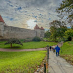 This picture captures a slice of Tallinn, Estonia’s medieval city walls, complete with its famous towers. The towers are part of the remarkably well-preserved defenses that wrap around Tallinn’s Old Town. These towers are linked by the old defensive walls that were built between the 13th and 16th centuries. The whole area is a centerpiece of Tallinn’s UNESCO-listed Old Town and a favorite spot for visitors to explore.