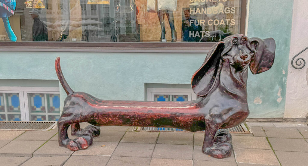 A quirky dachshund bench in front of one of the shops.