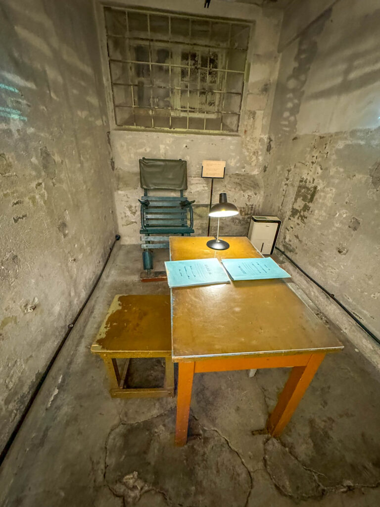 An interrogation room that includes a chair equipped with restraints -  a seat you'd definitely want to avoid.