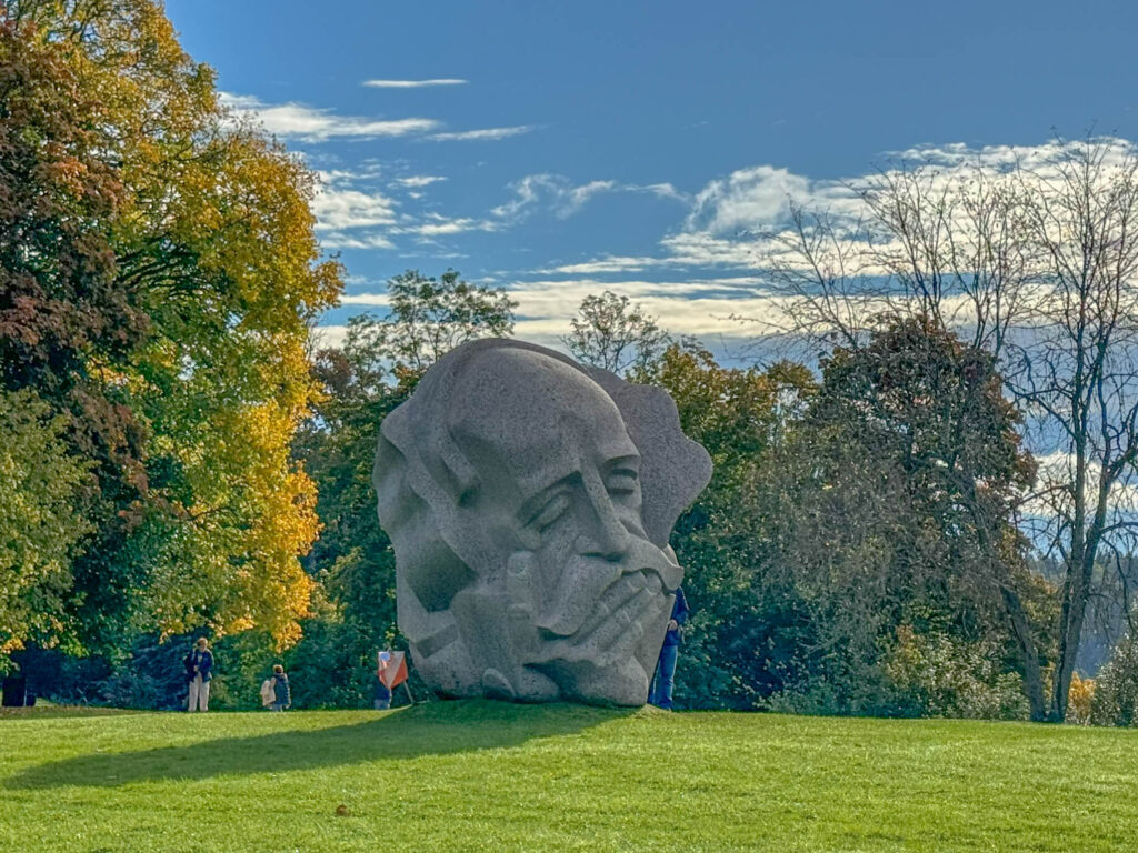 The sculpture "Father of Song" serves as a tribute to the collective memory of the Latvian people, their life lessons, and their dedication to preserving and passing down folk songs through the generations. Keeping cultural traditions alive isn’t just a responsibility—it’s a gift. It takes effort, sure, but it thrives on goodwill and mutual support. On one side of the sculpture, you’ll find an image of an honored elder. He’s the guardian of songs, a creator who could spin melodies for anyone and anything: “A song for him, a song for her, for just a piece of bread.”