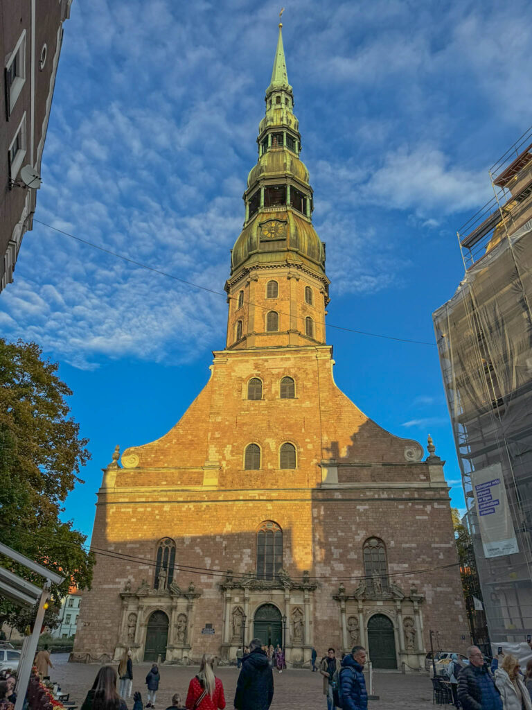 Here's a look at the exterior of St. Peter's Church. Originally built in the 13th century, this historic site has survived fires, wars, and countless renovations. I'm told it's a mix of Gothic, Baroque, and Romanesque styles. The spire stands an impressive 404 feet (123 meters) tall and had to be rebuilt after WWII. Once a hub for both prayer and local gatherings, St. Peter’s now hosts concerts, exhibits, and tourists with cameras.