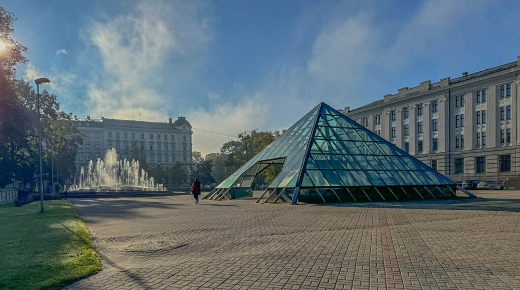 This pyramid-shaped structure is part of the Latvian Academy of Sciences complex in Riga, located near Bastejkalna Park and the National Opera area. It serves as a skylight entrance for an underground passage that connects parts of Riga's city center, near Vērmanes Garden or Esplanāde Park.