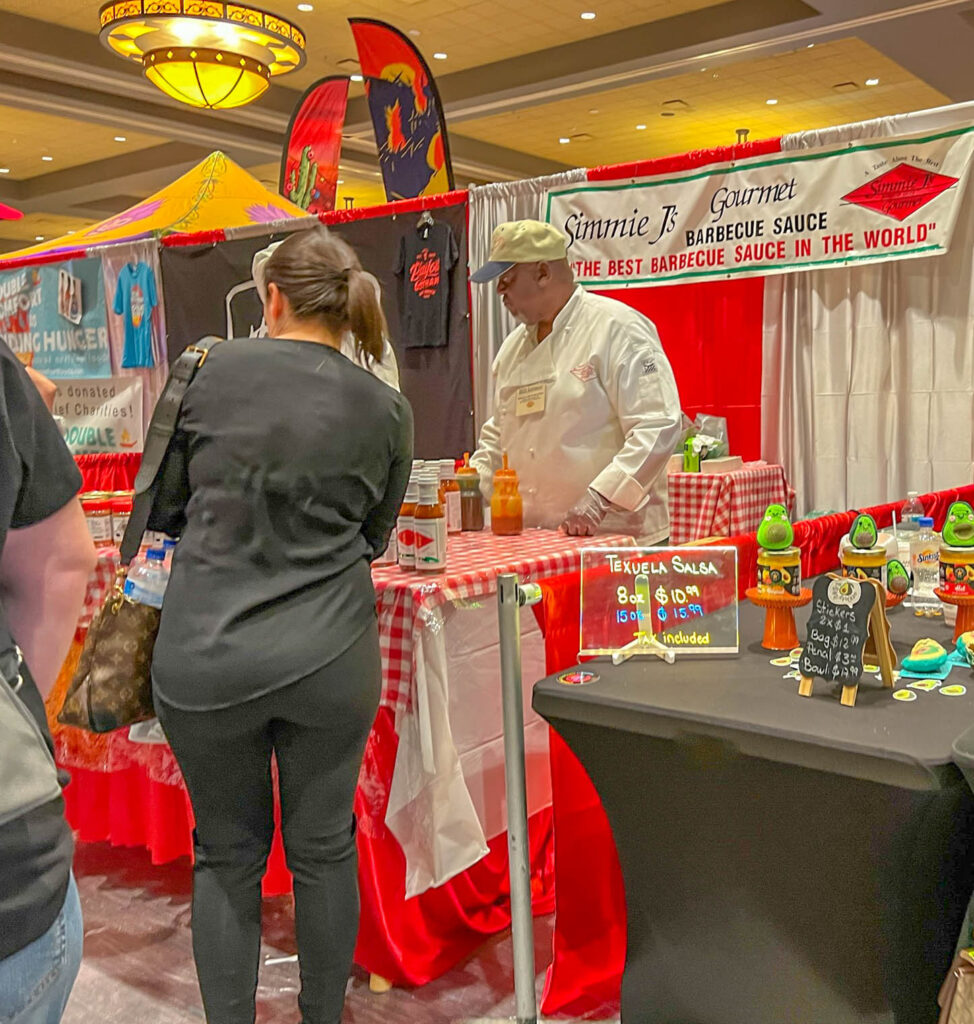 A vendor showcasing the BBQ section at the Fiery Foods and BBQ Show