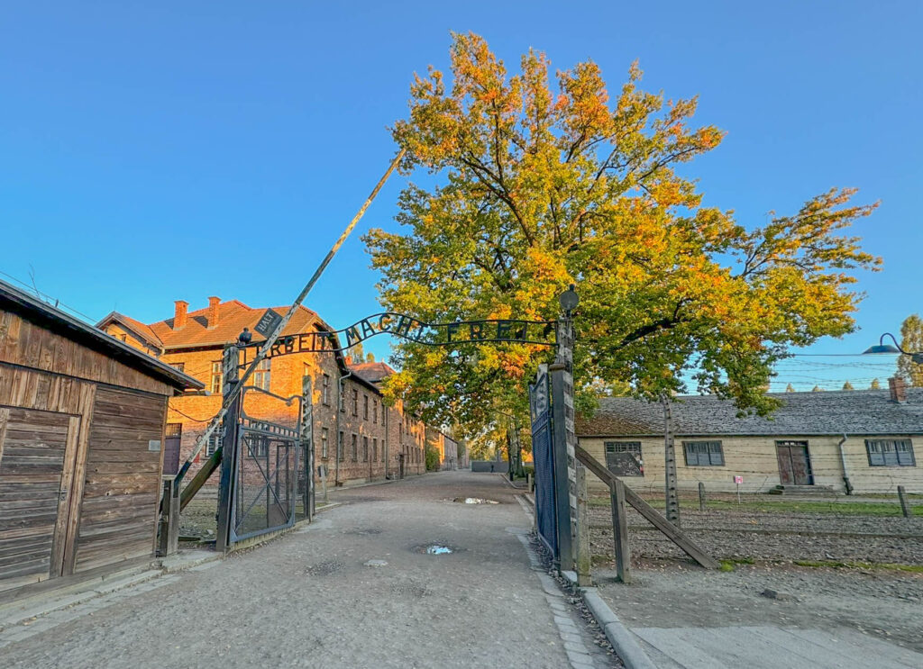 This image shows the main entrance gate to Auschwitz I, featuring the infamous inscription “Arbeit Macht Frei” ("Work Sets You Free"). This deceptive slogan was used by the Nazis to give prisoners false hope, masking the horrific reality of the concentration camp. The gate, now a powerful symbol of the Holocaust, leads into the preserved site where millions visit to remember the victims and reflect on history.