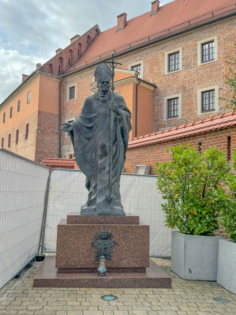 This statue on Wawel Hill depicts Pope John Paul II, who was born in Poland and served as Archbishop of Kraków before becoming pope in 1978. The statue honors his deep connection to Kraków, his influence on Poland’s spiritual and political history, and his role in inspiring resistance against communism. Similar statues of John Paul II can be found throughout Poland, reflecting his lasting impact on the country and the Catholic Church.