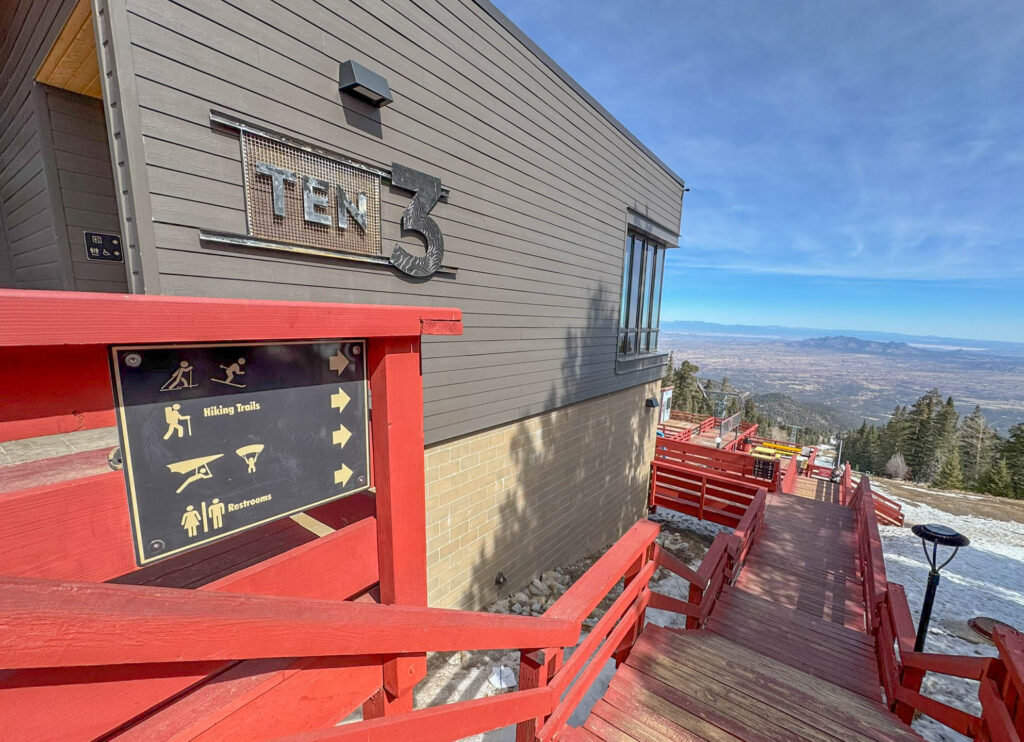 To the east, you’ll see Sandia Peak Ski Area and nearby "East Mountain" towns like Sandia Crest, Cedar Crest, and Edgewood. If you glance at the activity sign, it's pretty clear this spot is an outdoor lover's paradise - hiking, mountain biking, and even hang gliding or paragliding for the pros. In the winter, you’ll find options for downhill skiing (if there’s enough snow), Nordic skiing, and snowshoeing. Not into outdoor sports? No problem. The "Ten 3" restaurant at the summit serves good food and drinks, paired with fantastic views, especially at sunset.