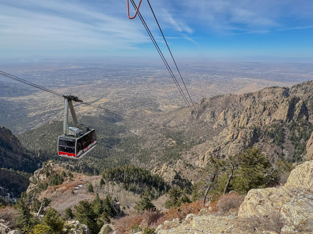 The Sandia Peak Tram glides toward the top, reaching an impressive height of 10,378 feet. From the top, you’re treated to sweeping views of Albuquerque sprawled below and the rugged, sun-soaked shrublands stretching out to the west.