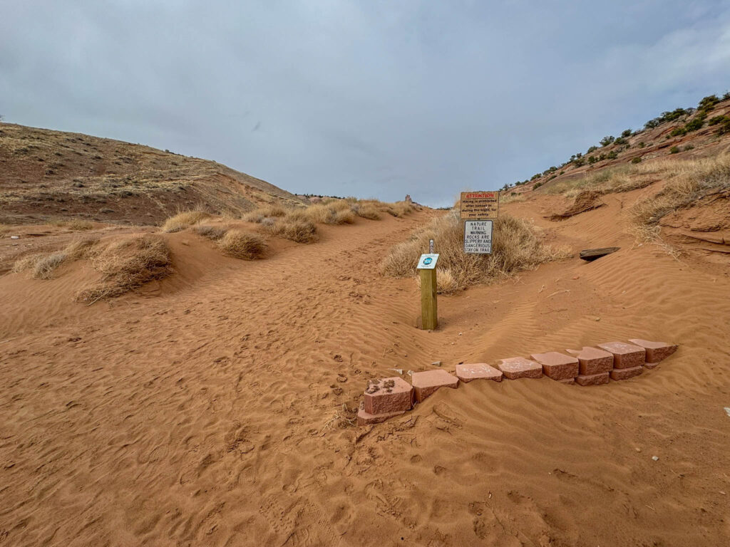 Church Rock Trail travels through soft sand and climbs up toward the slickrock. Trails are open during daylight hours only, and the rock can be steep and slippery when wet—so good shoes (and good judgment) go a long way.