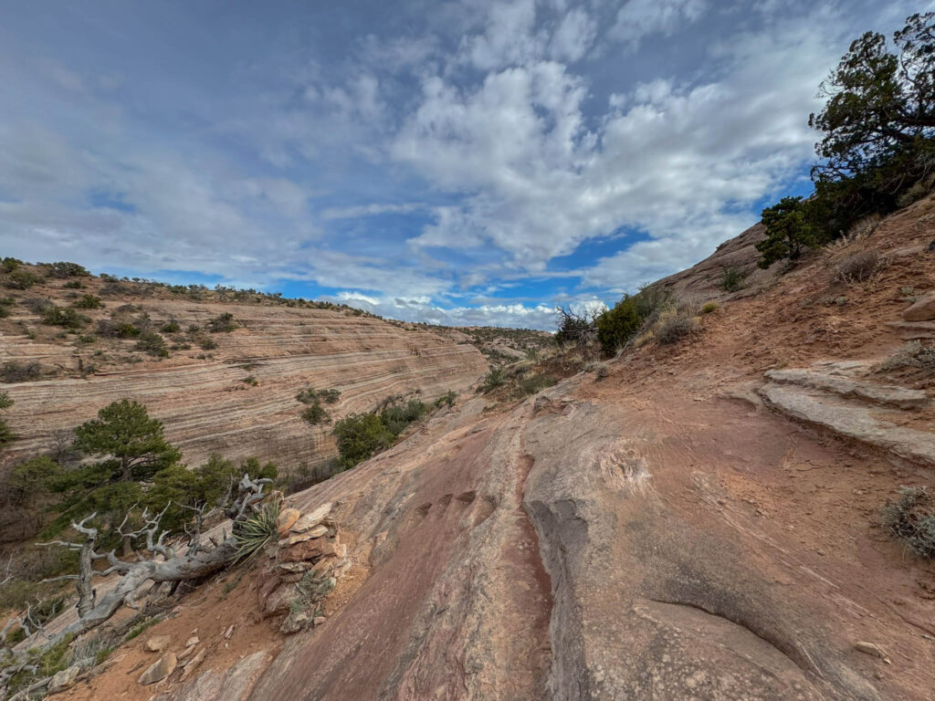 Here’s where the Church Rock Trail shifts from soft sand to solid stone. The views open up, the footing gets trickier—and the real fun begins.