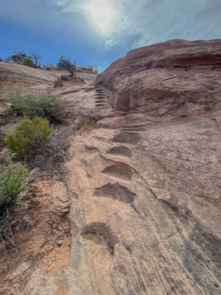 In steeper sections of the slickrock, steps have been carved right into the stone—offering a bit of traction and a reminder that you’re not the first one to climb this route.