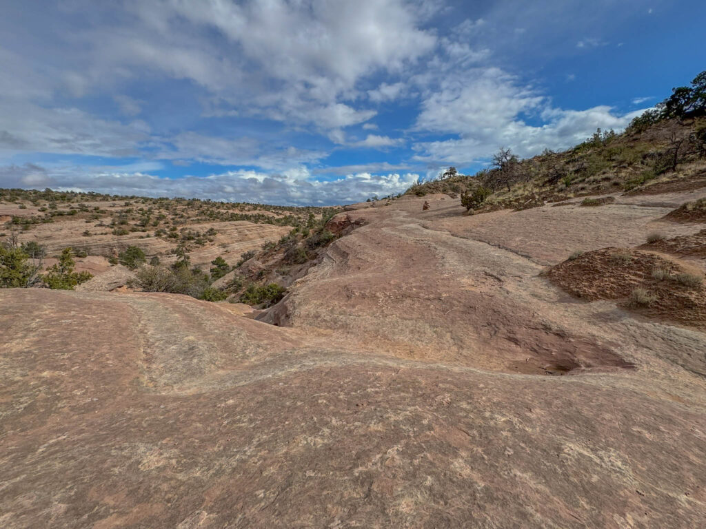 It’s sections like this where cairns really earn their keep. With no defined path across the slickrock, those little stacks of stone are your best bet for staying on course.
