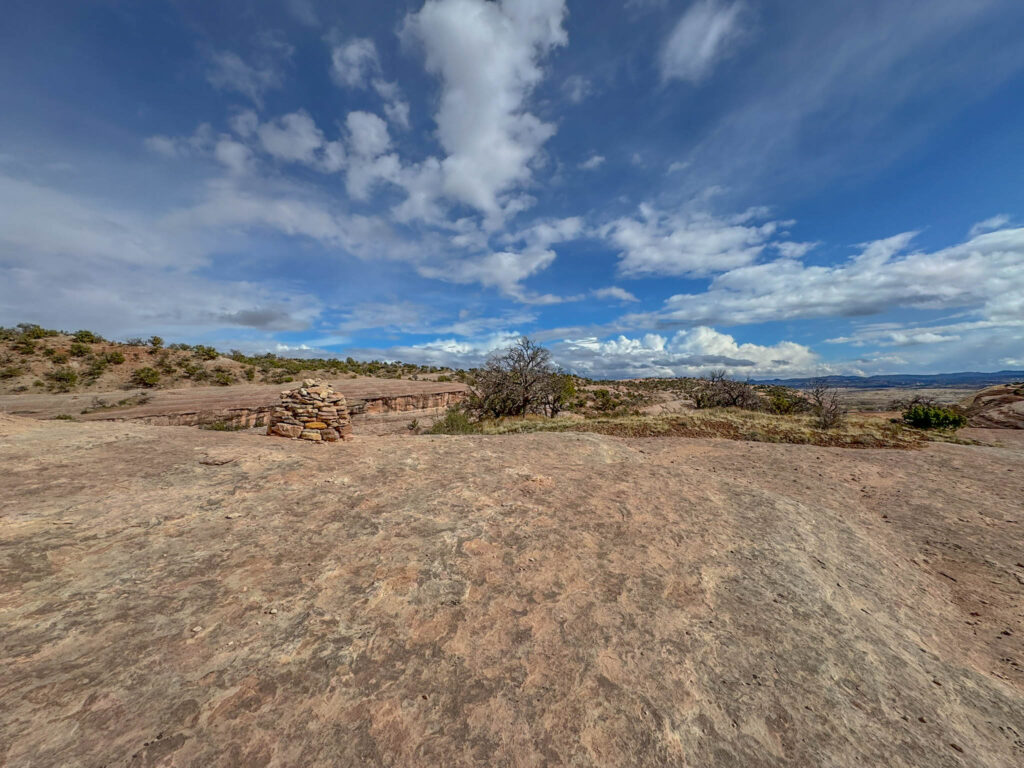 Another view of the cairns that guide your way across the slickrock.