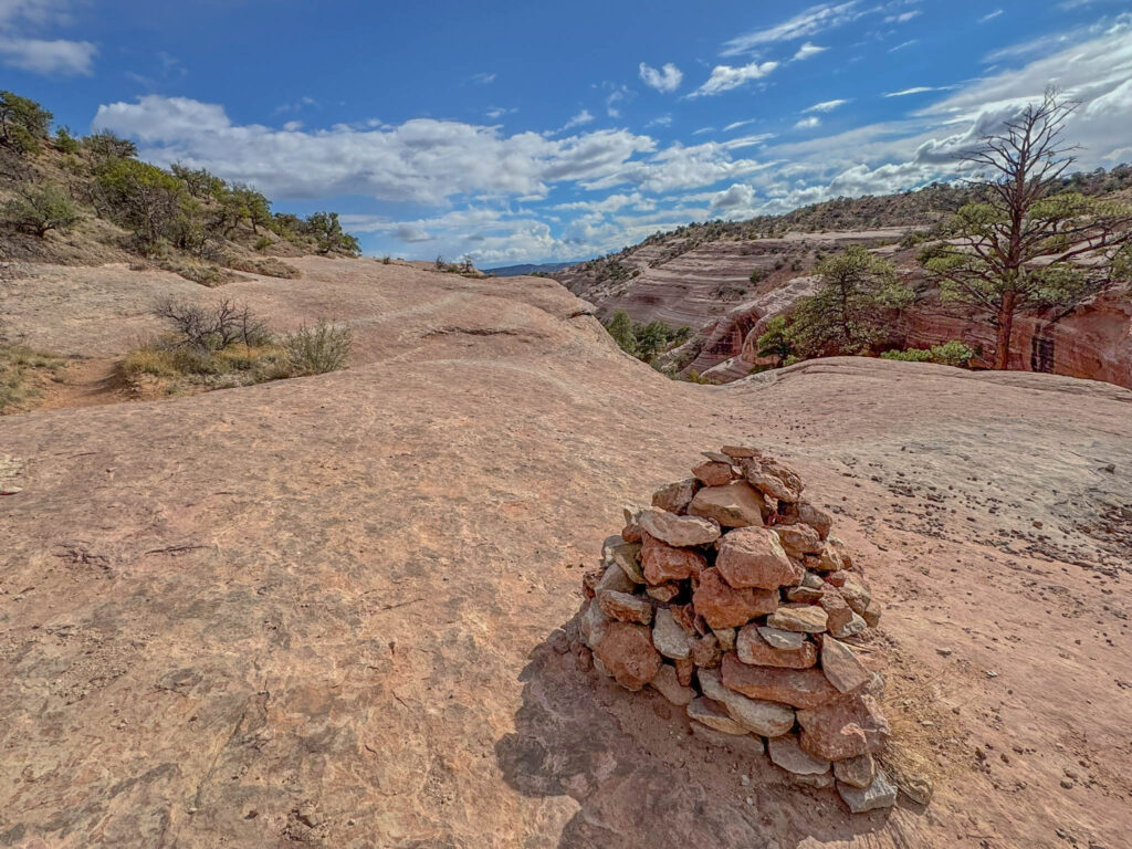 Another view of the fascinating landscape along the Church Rock Trail—layers of wind-sculpted sandstone, open sky, and the occasional cairn to keep you pointed in the right direction.