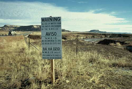 A warning sign posted by the New Mexico Environmental Improvement Division near the Puerco River, following the 1979 Church Rock uranium mill spill—the largest release of radioactive waste in U.S. history. (Photo credit: Wikimedia Commons)