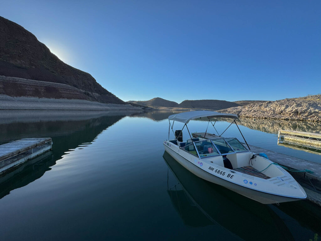 A quiet morning at Dam Site Marinaāflat water, cool air, and one boat ready to chase the first light across the lake.