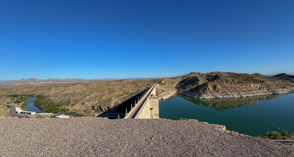 One dam, two worlds: the calm reservoir to the right, and the Rio Grande stretching out to the left.