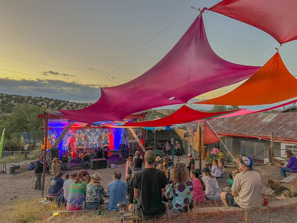 A scene from the “Madrid Is Dead” festival, where fans gathered under desert skies to celebrate the legacy of Jerry Garcia and The Grateful Dead. The event featured New Mexico’s ‘Big 3’ tribute bands: Detroit Lightning, Lonn Calanca Band, and The Deal.