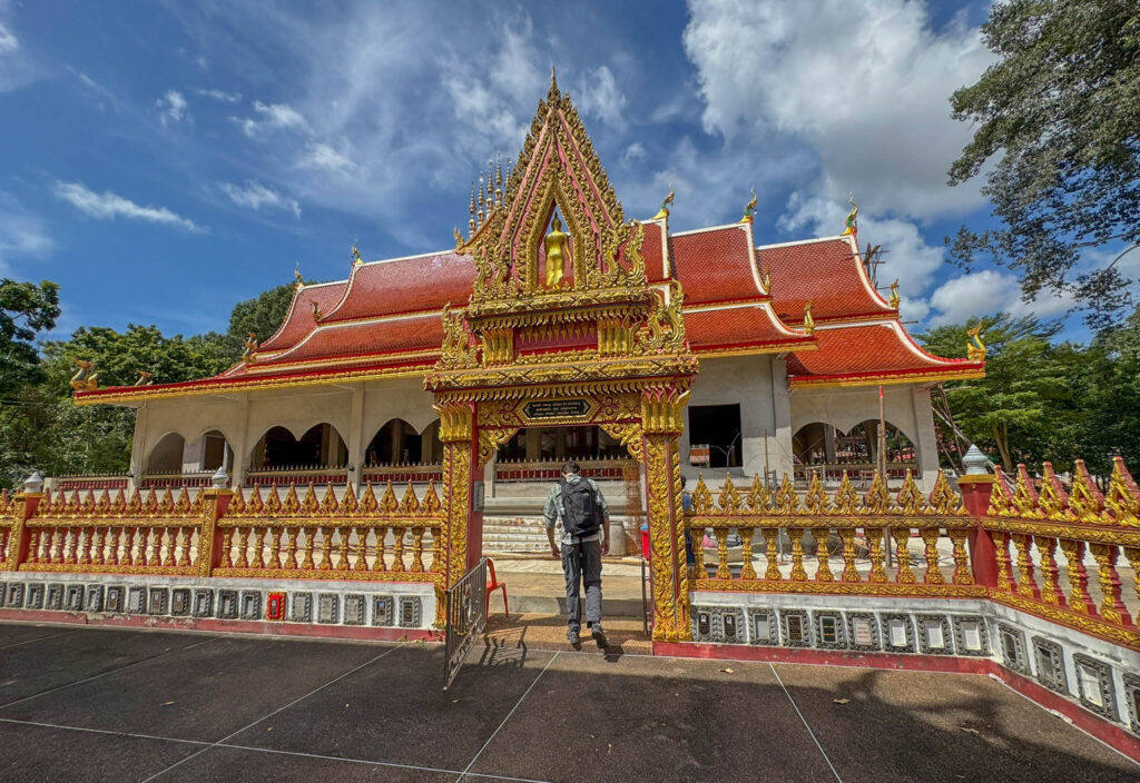 Walking from an 800 year old Khmer ruin straight into a fully active Thai temple.
