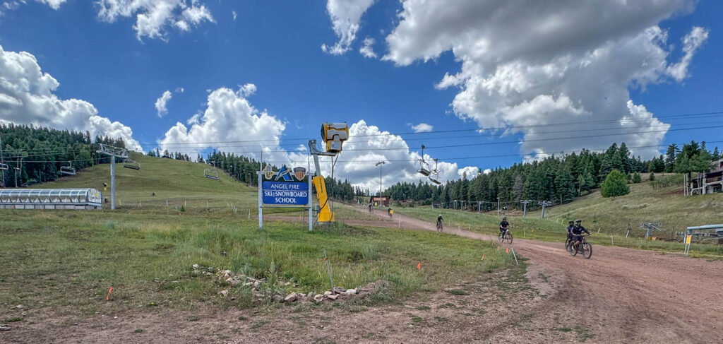Mountain bikers descend the slopes at Angel Fire Bike Park during the summer season.