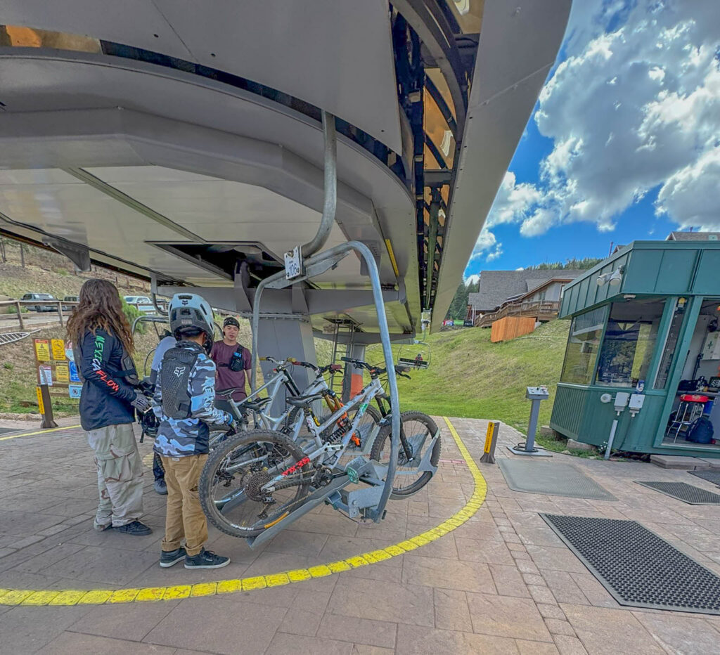 Mountain bikes are loaded onto the Chile Express, where bike racks alternate with passenger chairs for the ride to the top of Angel Fire Bike Park.