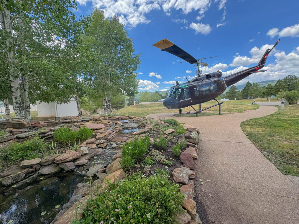 A restored UH-1 Huey helicopter on display at the Vietnam Veterans Memorial in Angel Fire.