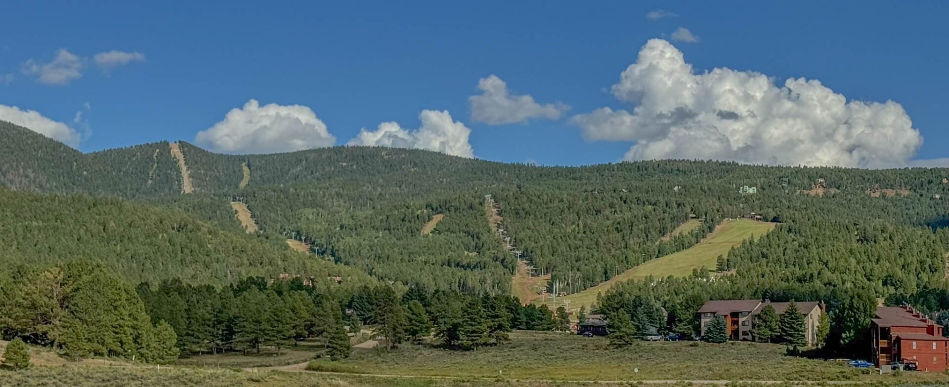 Angel Fire Resort in summer, where the ski slopes transform into hiking trails, mountain bike runs, and scenic chairlift rides.