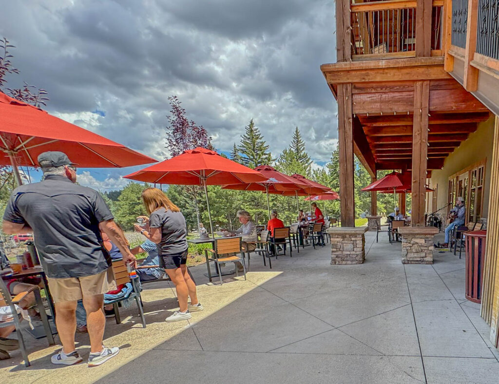 Outdoor dining comes with mountain views and, on this afternoon, live music at Angel Fire Country Club.