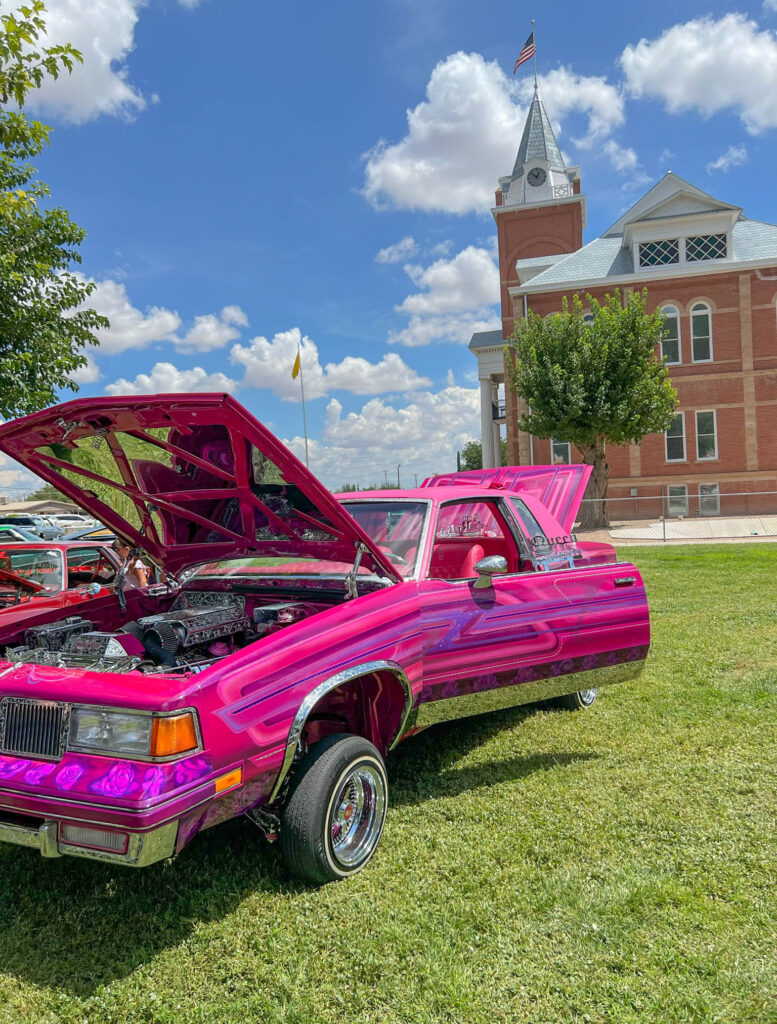 A colorful entry in the Great American Duck Race car show, with the Luna County Courthouse in the background.
