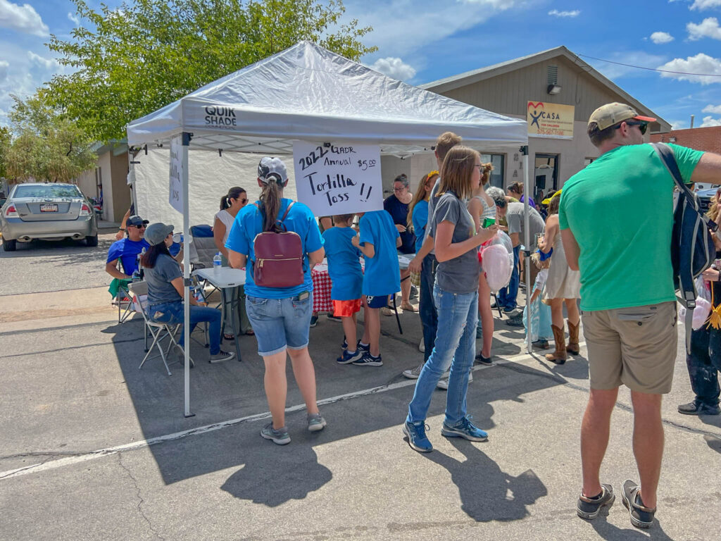 Signing up for the Great American Tortilla Toss. Five dollars bought me two chances to discover that flour tortillas are surprisingly difficult to throw.