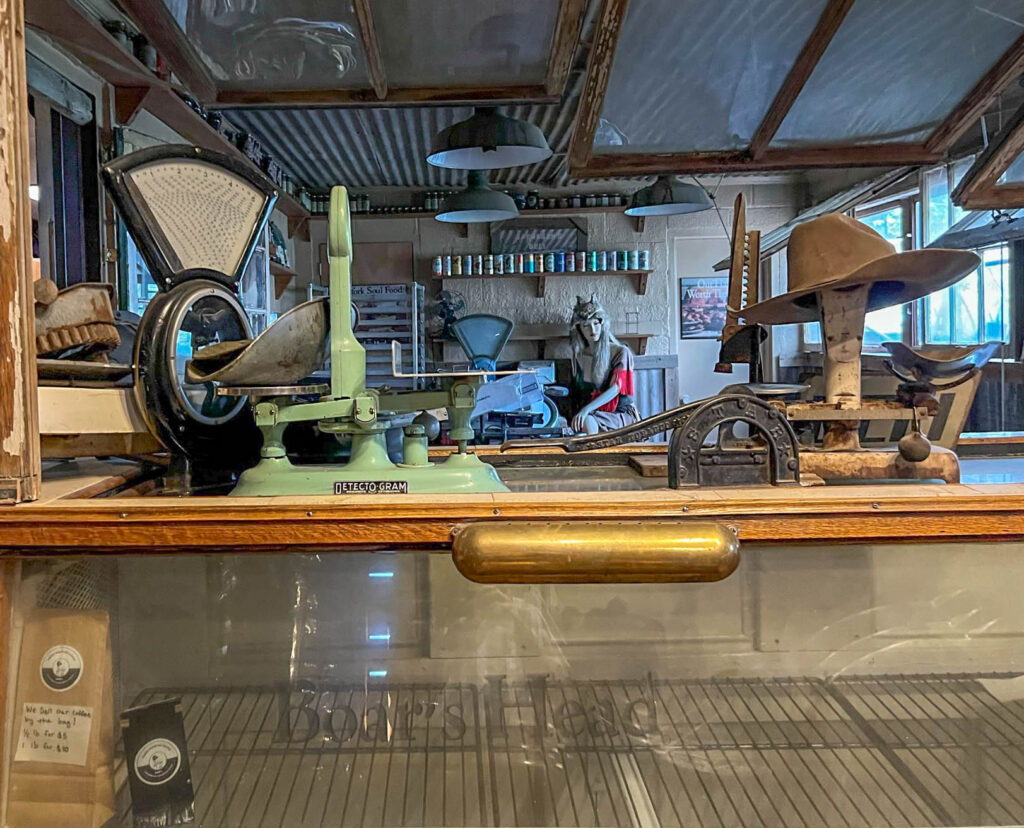 The old deli counter at Adobe Deli, complete with antique equipment and a mannequin sporting some interesting headgear in the background.